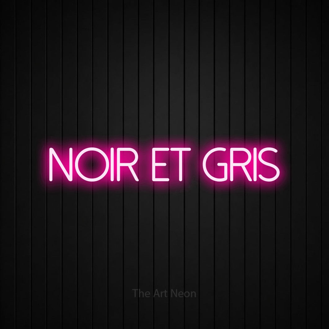 “Noir et gris” LED neon sign in hot pink, with thin sans-serif lettering, shown against black vertical wall slats.