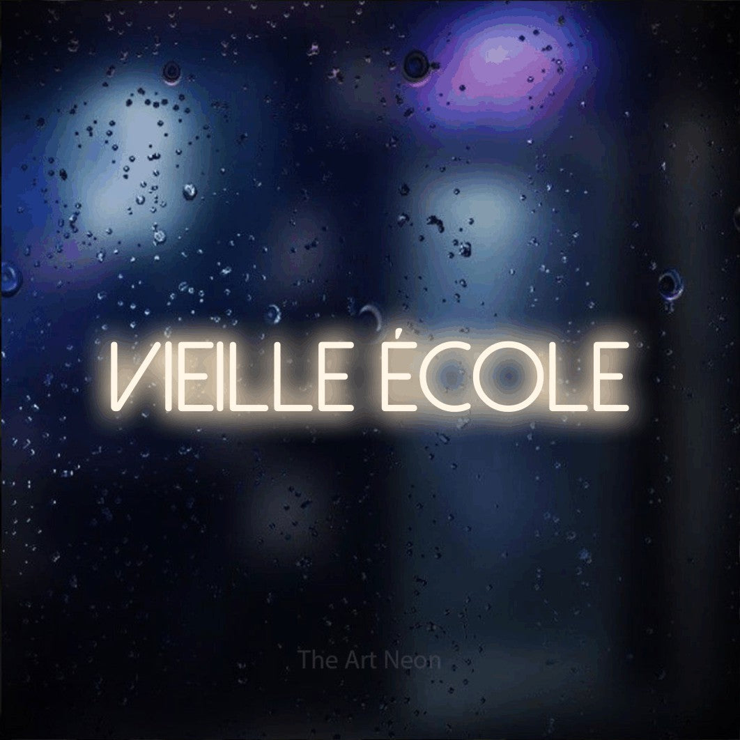 “Vieille école” LED neon sign in warm white, with thin sans-serif lettering, shown against glass with blue and purple reflections.