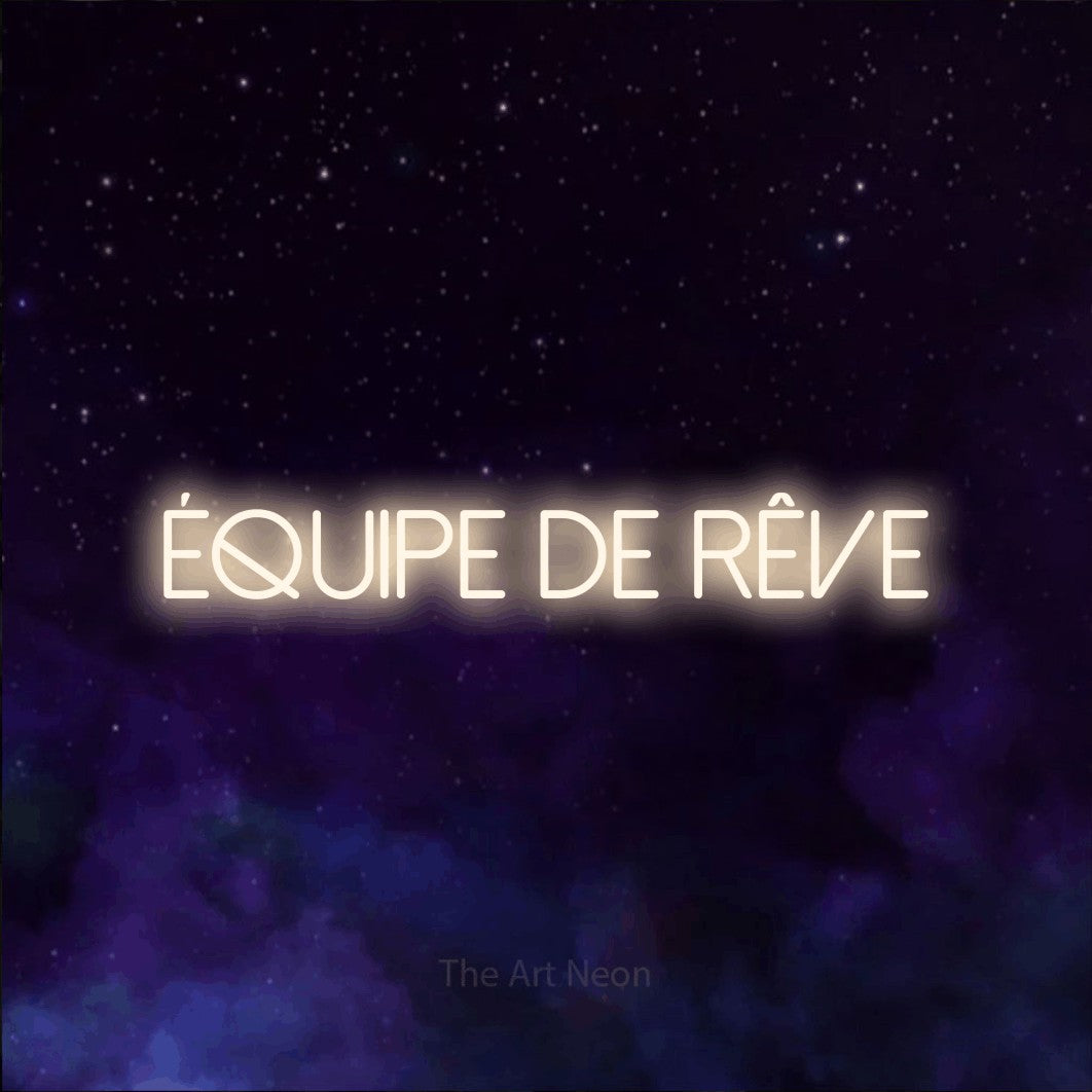“Équipe de rêve” LED neon sign in warm white, with thin sans-serif lettering, shown against a purple galaxy backdrop.