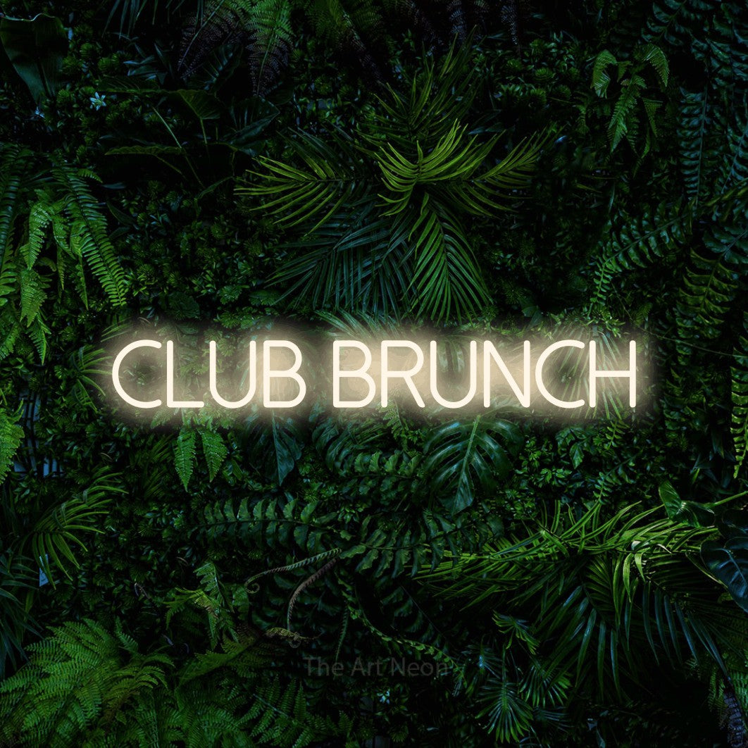 “Club brunch” LED neon sign in warm white, with thin sans-serif lettering, shown against dense tropical foliage.