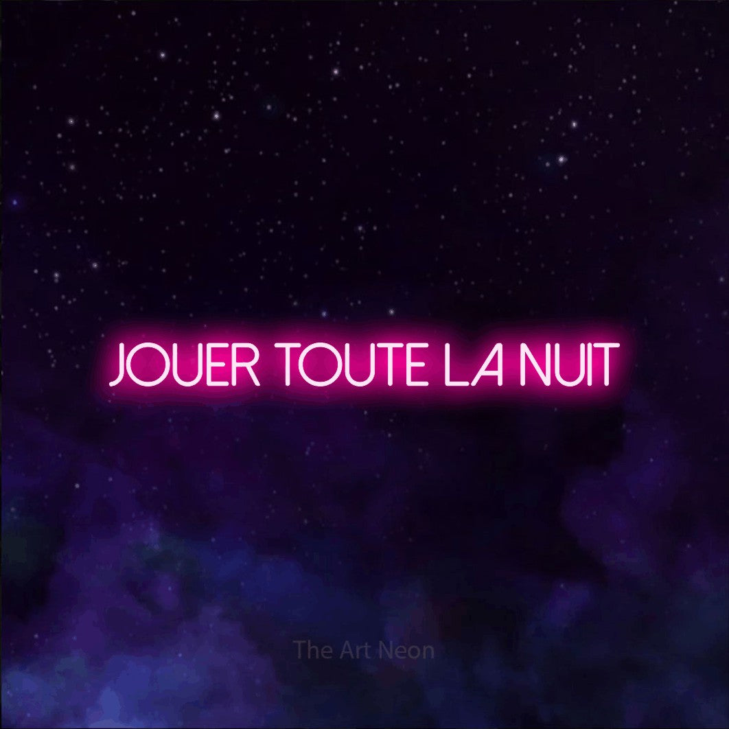 “Jouer toute la nuit” LED neon sign in hot pink, with thin sans-serif lettering, shown against a purple galaxy backdrop.
