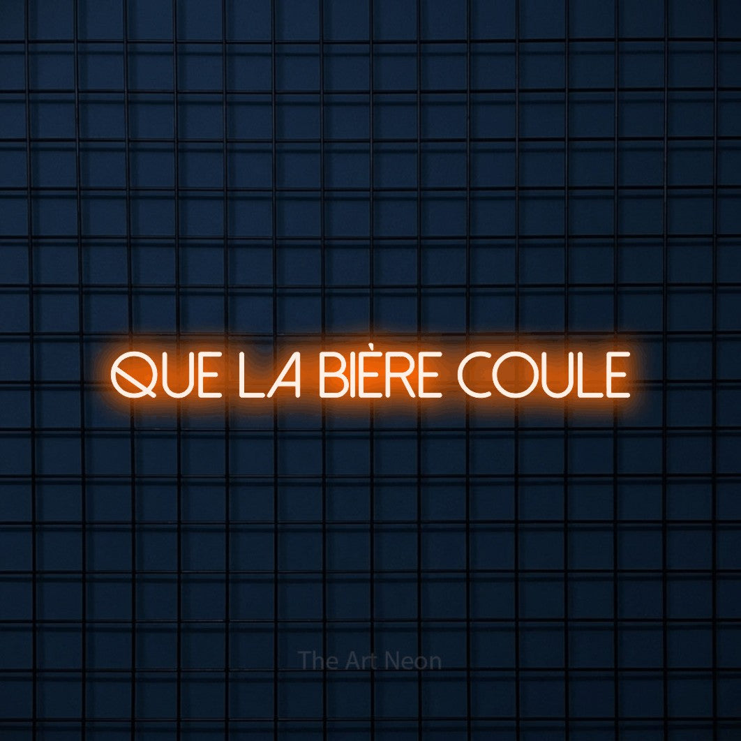 “Que la bière coule” LED neon sign in orange, with thin sans-serif lettering, shown against a dark blue grid.