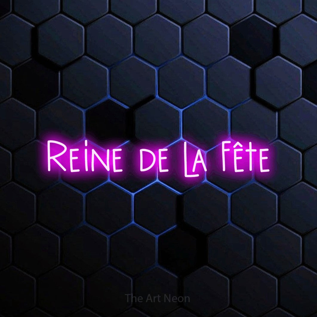 “Reine de la fête” LED neon sign in pink, with narrow hand-drawn lettering, shown against a dark blue honeycomb pattern.