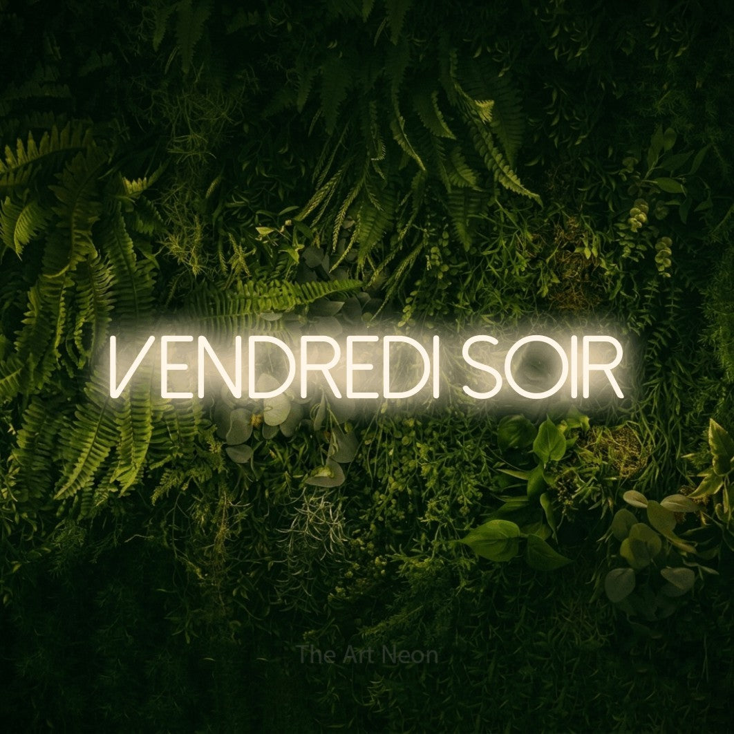 “Vendredi soir” LED neon sign in warm white, with thin sans-serif lettering, shown against a dark moss and forest backdrop.