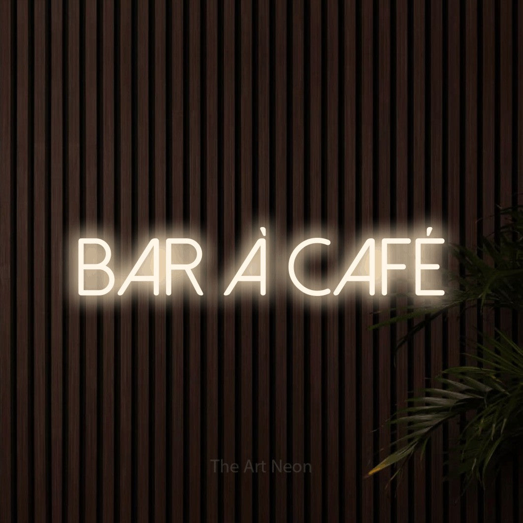 “Bar à café” LED neon sign in warm white, with thin sans-serif lettering, shown against dark wooden wall slats.