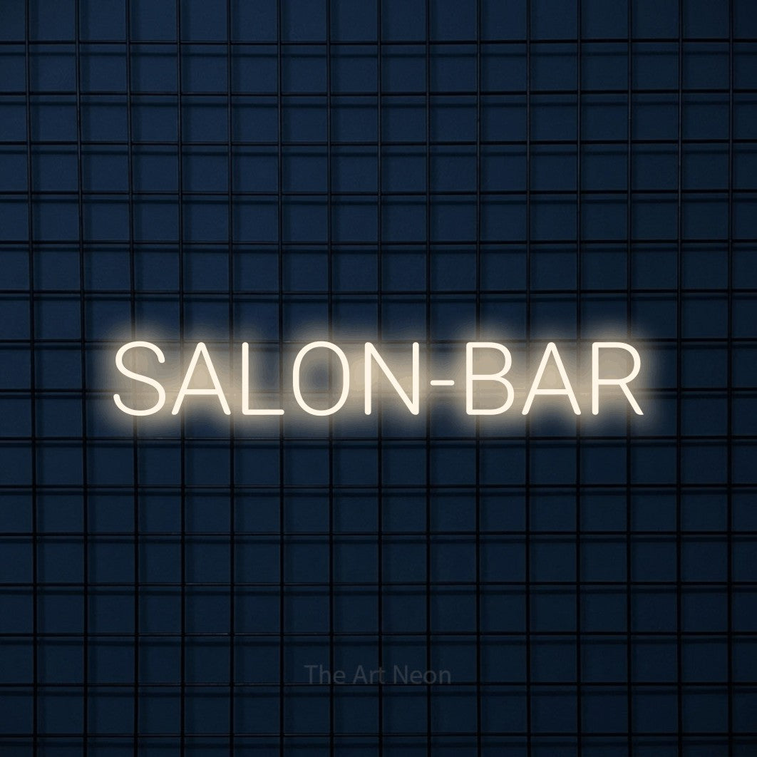Enseigne néon LED « Salon-bar » en blanc chaud, en lettres sans empattement arrondies, présentée sur une grille bleu foncé, pour un bar ou un pub.