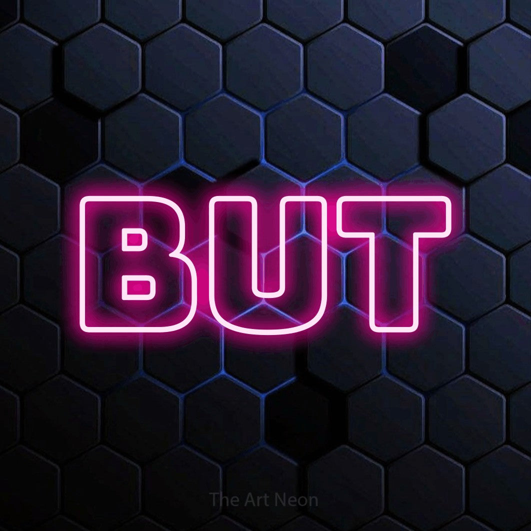 “But” LED neon sign in hot pink, with bold outline lettering, shown against a dark blue honeycomb pattern.