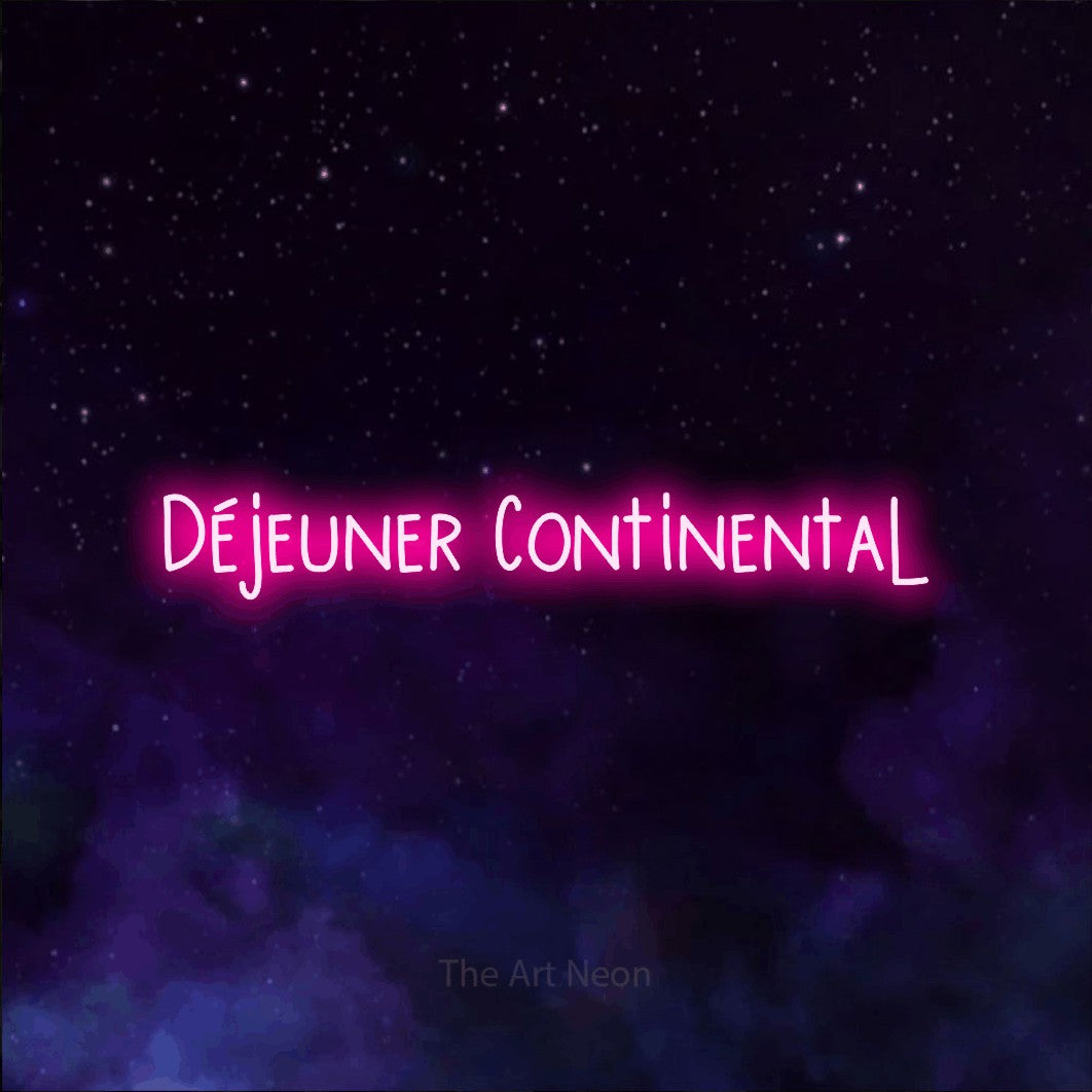 “Déjeuner continental” LED neon sign in hot pink, with narrow hand-drawn lettering, shown against a purple galaxy backdrop.