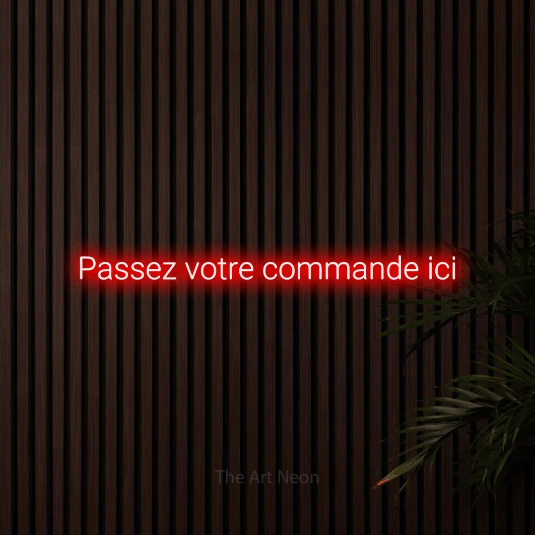 “Passez votre commande ici” LED neon sign in red, with rounded sans-serif lettering, shown against dark wooden wall slats.