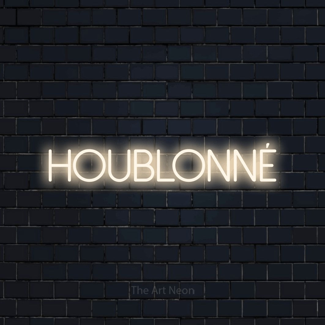 “Houblonné” LED neon sign in warm white, with thin sans-serif lettering, shown against a dark navy brick wall.