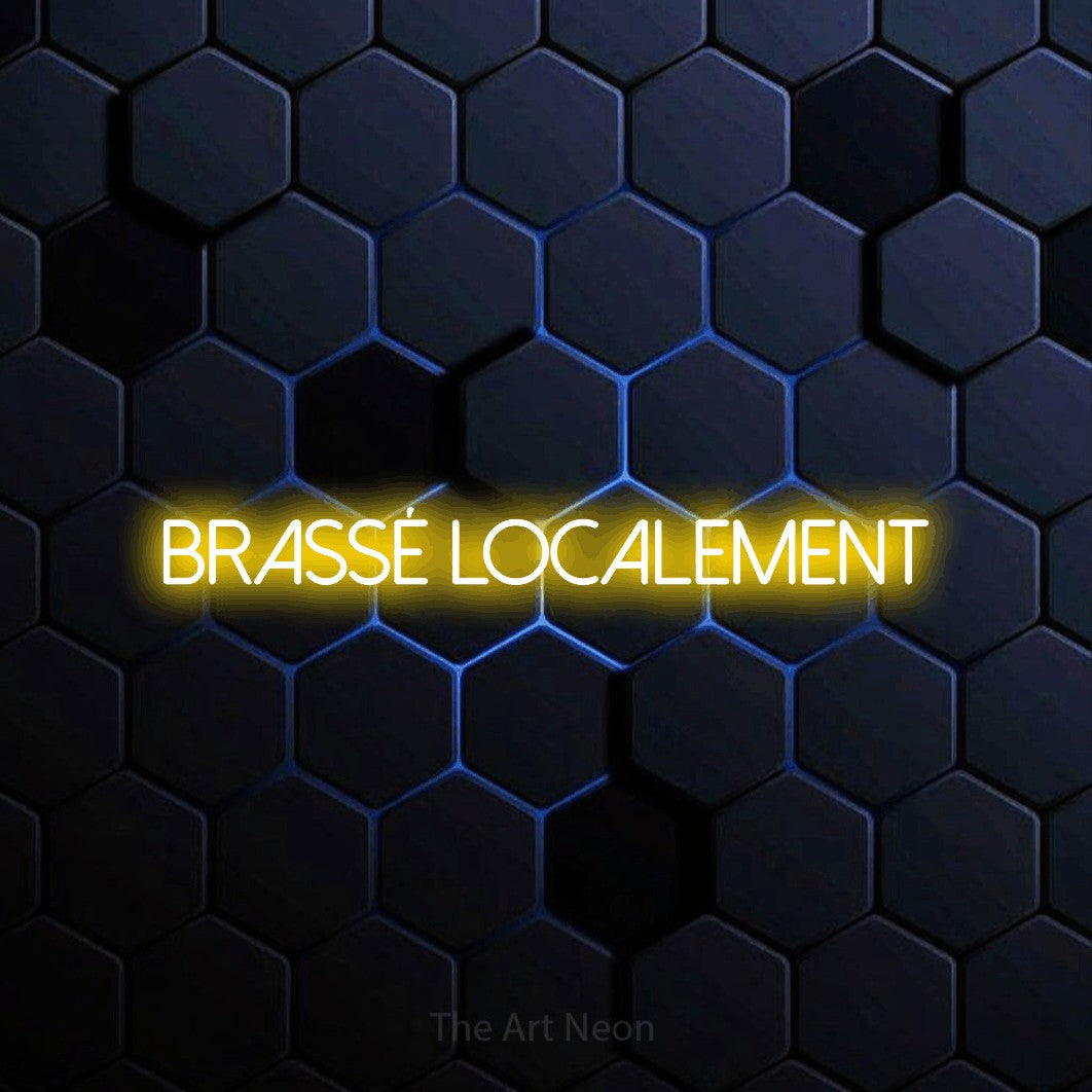 “Brassé localement” LED neon sign in yellow, with thin sans-serif lettering, shown against a dark blue honeycomb pattern.