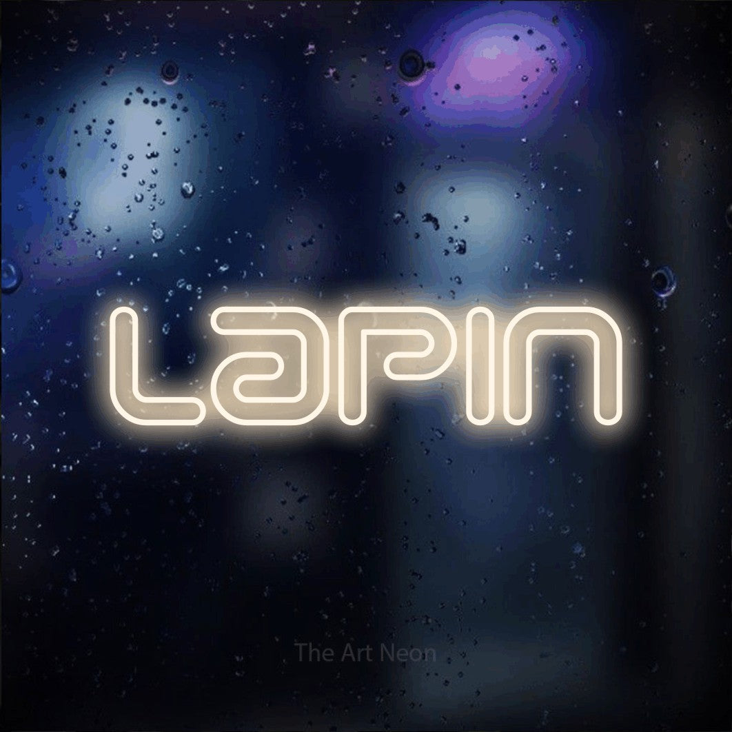 “Lapin” LED neon sign in warm white, with futuristic double-line lettering, shown against glass with blue and purple reflections.