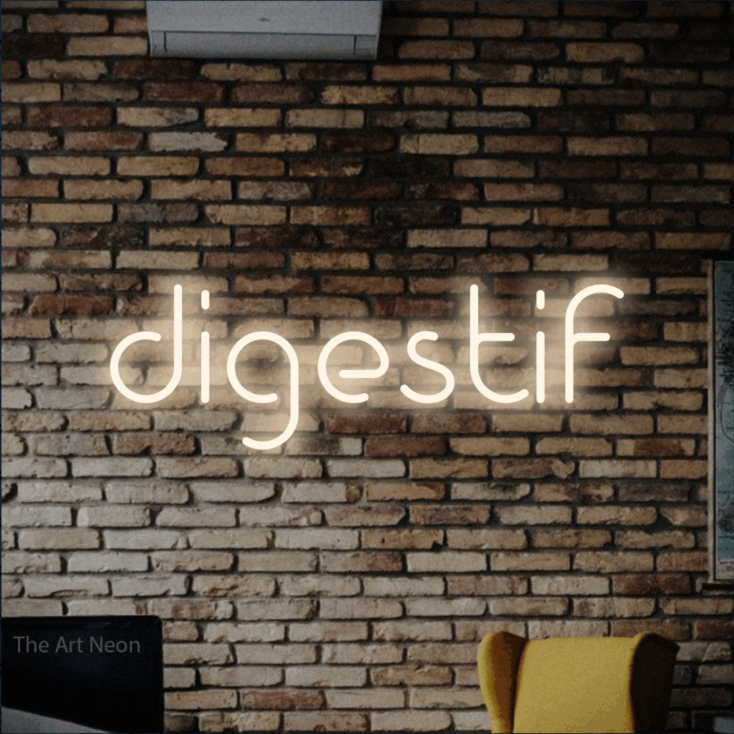 “Digestif” LED neon sign in warm white, with stylised geometric lettering, shown against warm-toned brickwork.