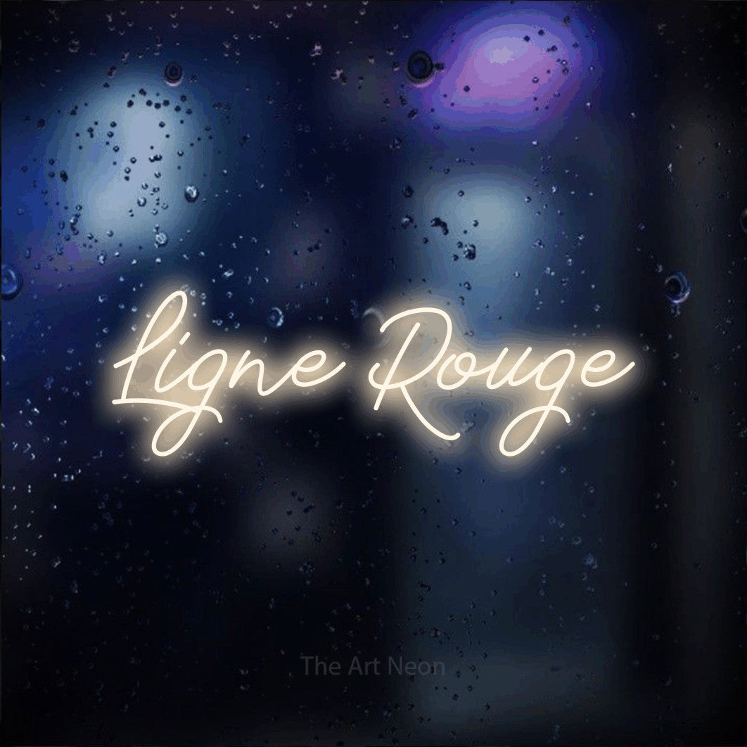“Ligne rouge” LED neon sign in warm white, with cursive lettering, shown against glass with blue and purple reflections.
