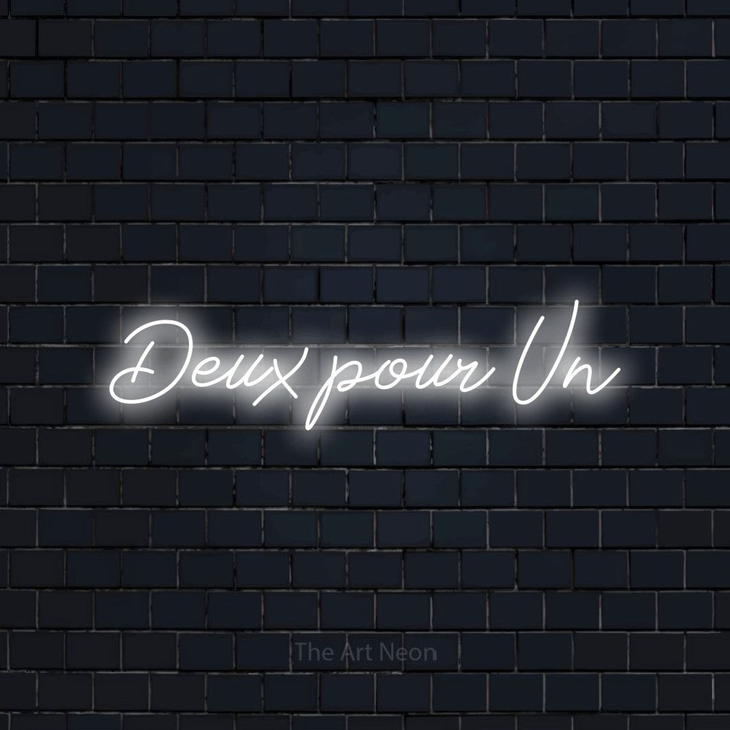 “Deux pour un” LED neon sign in cool white, with cursive lettering, shown against a dark navy brick wall.