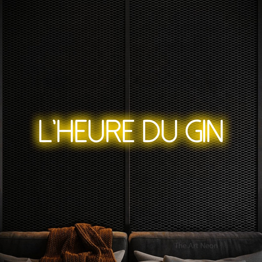 “L'heure du gin” LED neon sign in yellow, with thin sans-serif lettering, shown against a modern dark-toned seating area.