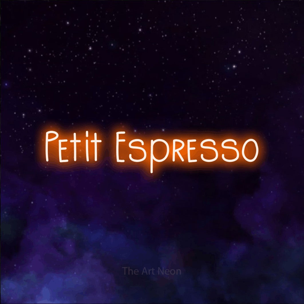 “Petit espresso” LED neon sign in orange, with narrow hand-drawn lettering, shown against a purple galaxy backdrop.