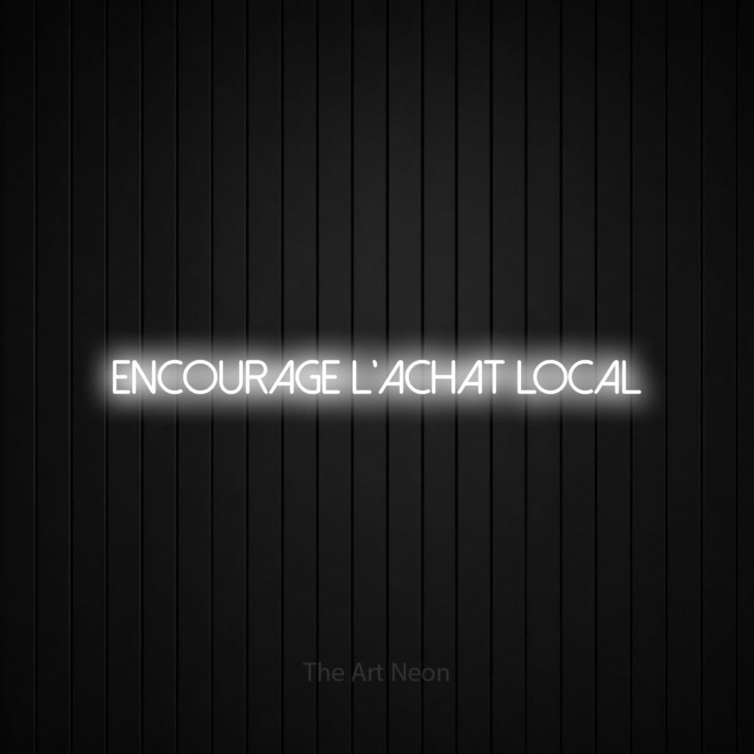 “Encourage l'achat local” LED neon sign in cool white, with thin sans-serif lettering, shown against black vertical wall slats.