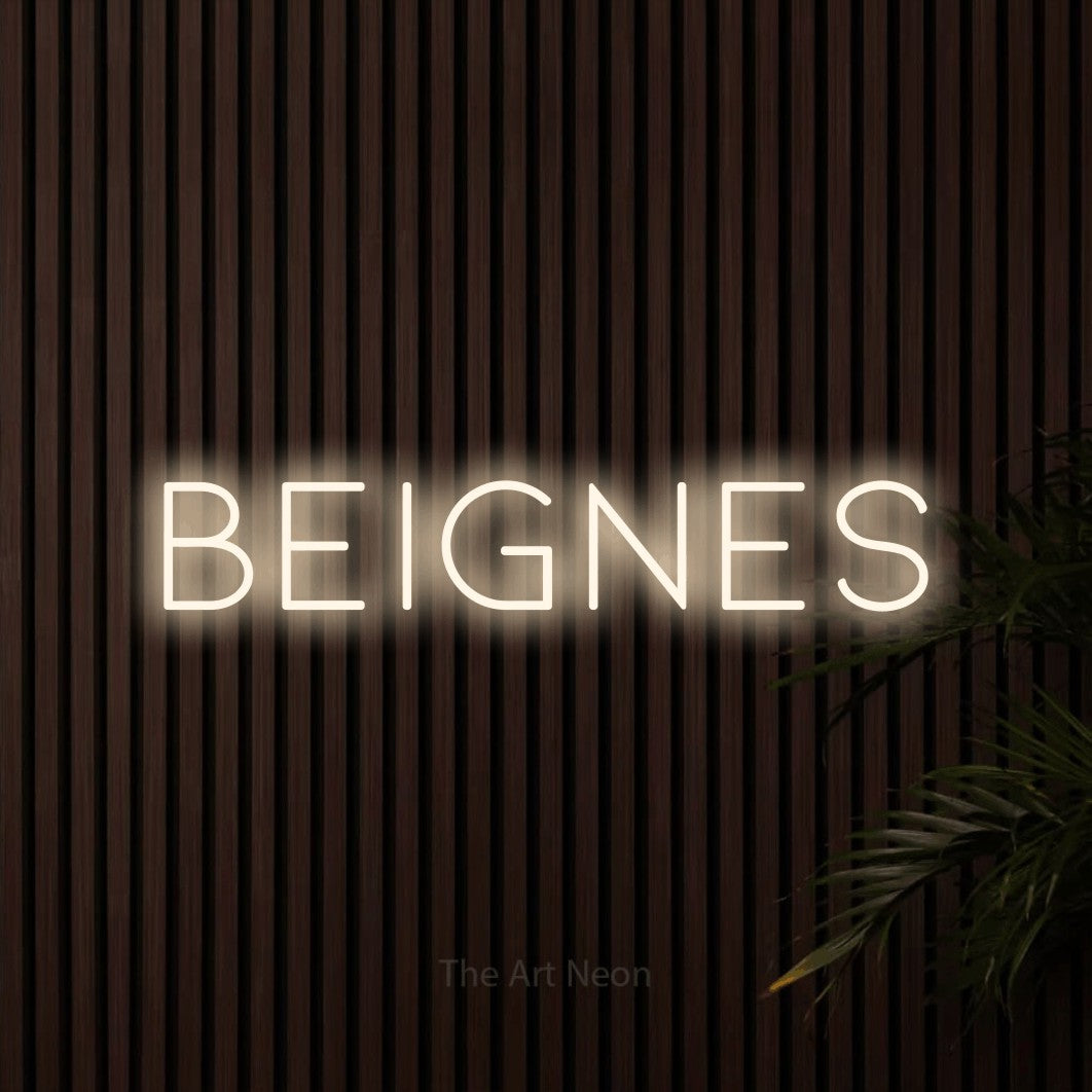 “Beignes” LED neon sign in warm white, with thin, widely spaced lettering, shown against dark wooden wall slats.