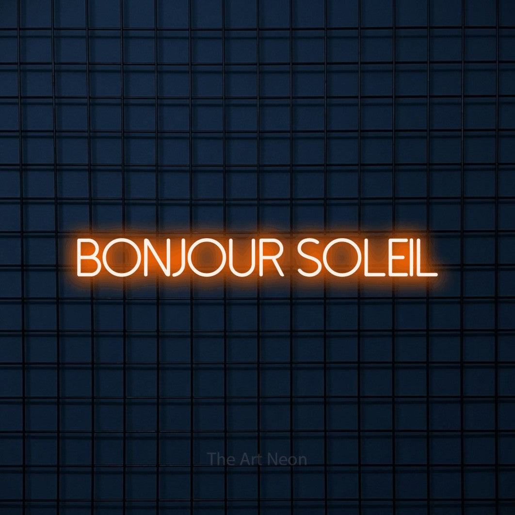 “Bonjour soleil” LED neon sign in orange, with thin sans-serif lettering, shown against a dark blue grid.
