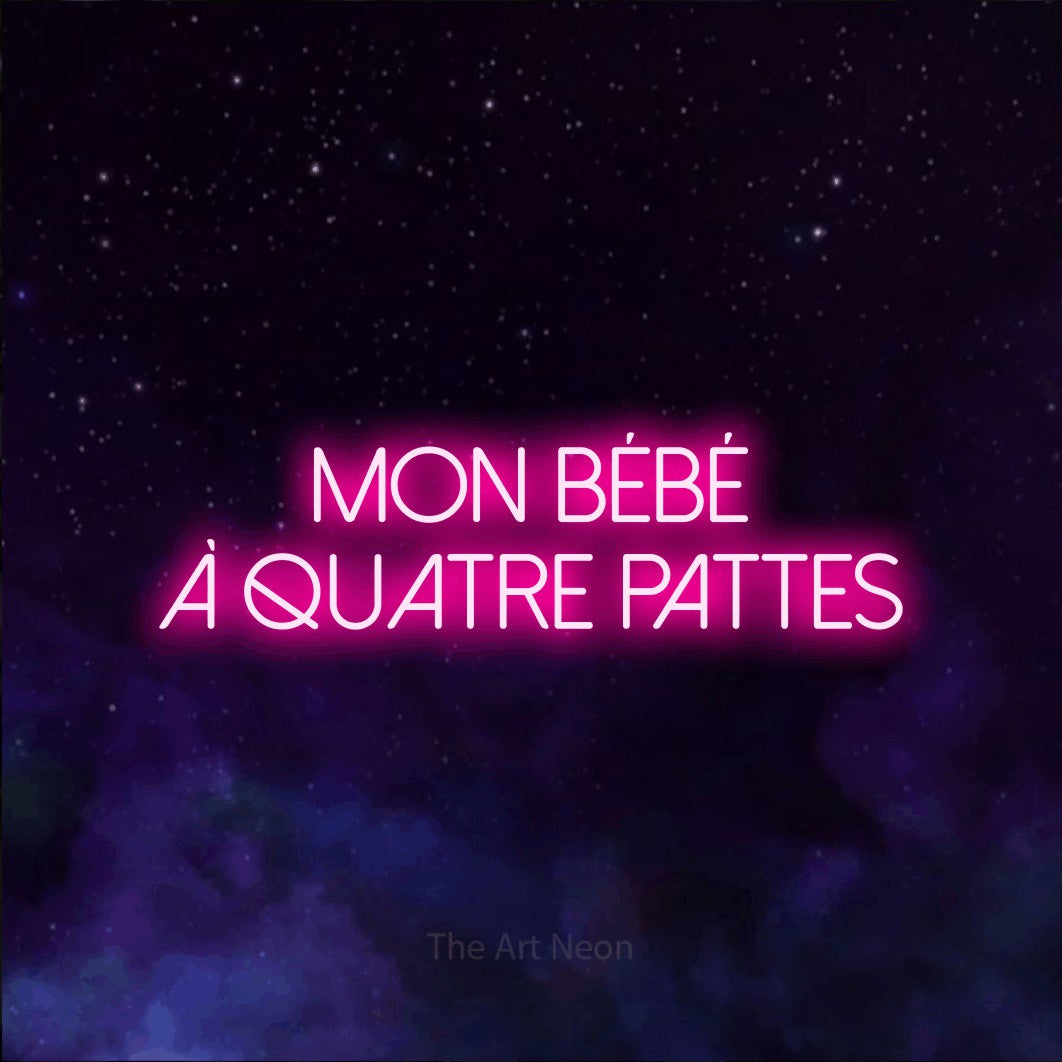 “Mon bébé à quatre pattes” LED neon sign in hot pink, with thin sans-serif lettering across 2 lines, shown against a purple galaxy backdrop.
