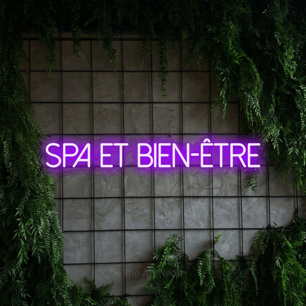 “Spa et bien-être” LED neon sign in purple, with thin sans-serif lettering, shown against an ivy-covered concrete grid.