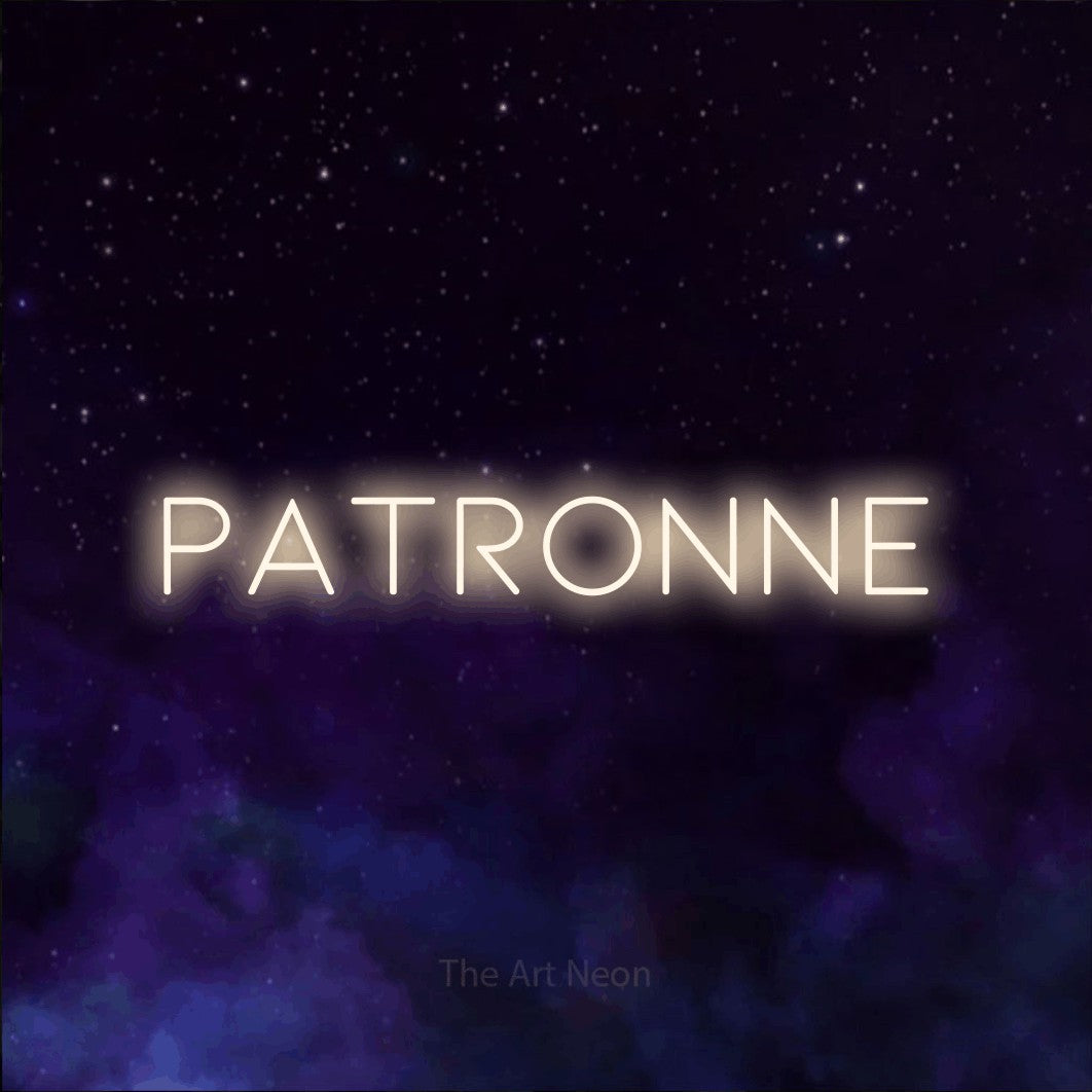 “Patronne” LED neon sign in warm white, with thin, widely spaced lettering, shown against a purple galaxy backdrop.