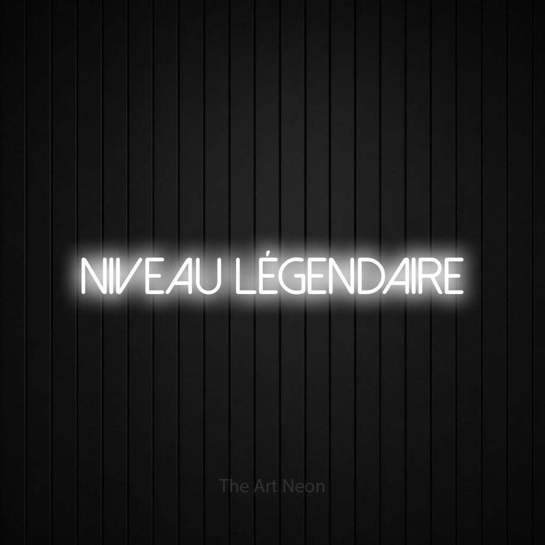 “Niveau légendaire” LED neon sign in cool white, with thin sans-serif lettering, shown against black vertical wall slats.