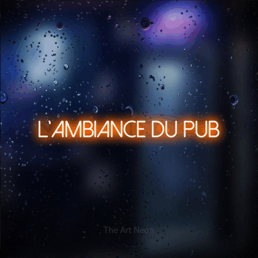 “L'ambiance du pub” LED neon sign in orange, with thin sans-serif lettering, shown against glass with blue and purple reflections.