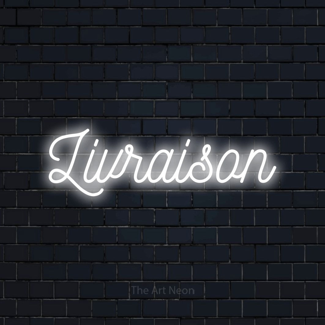 “Livraison” LED neon sign in cool white, with ornate cursive lettering, shown against a dark navy brick wall.