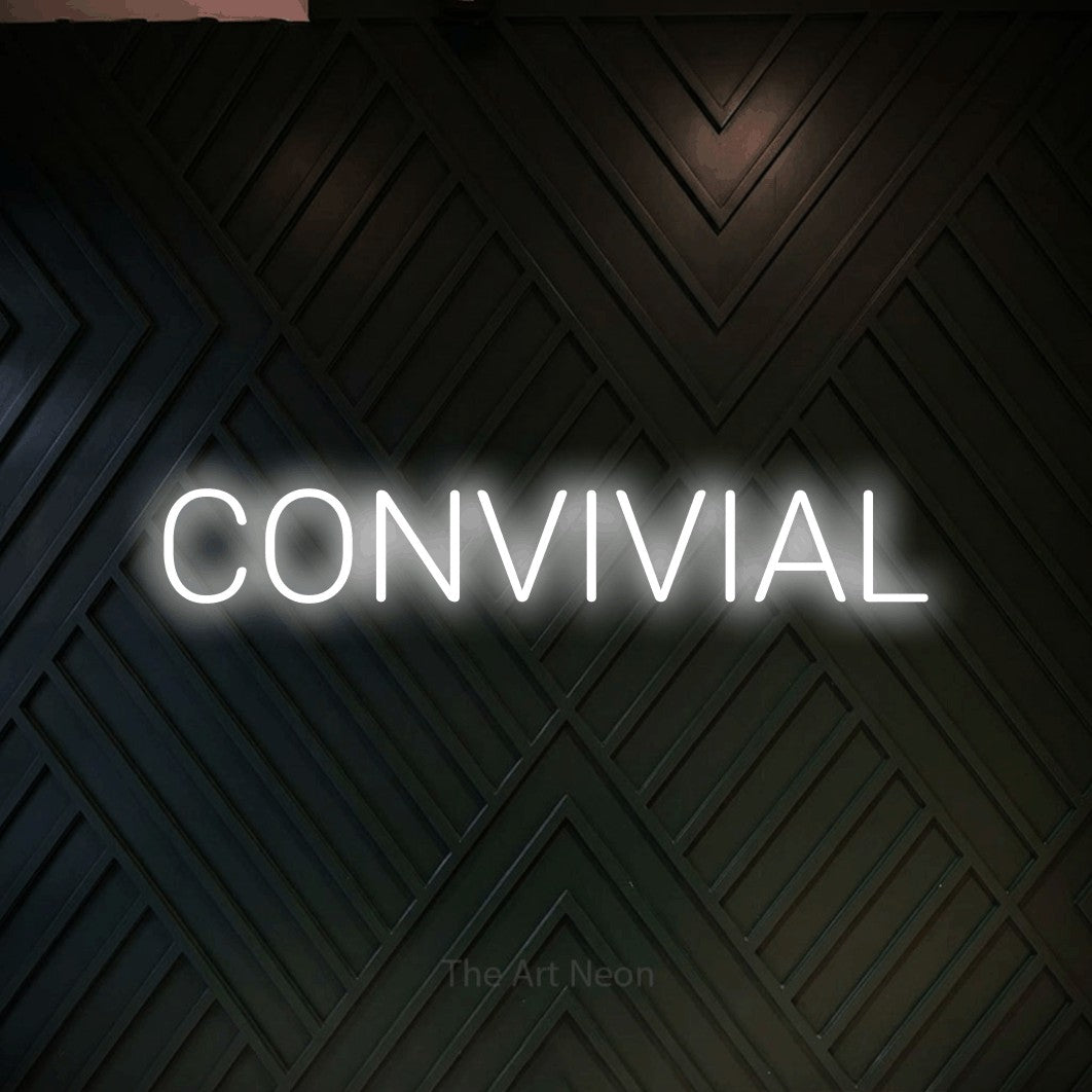 “Convivial” LED neon sign in cool white, with rounded sans-serif lettering, shown against a black chevron-patterned wood wall.