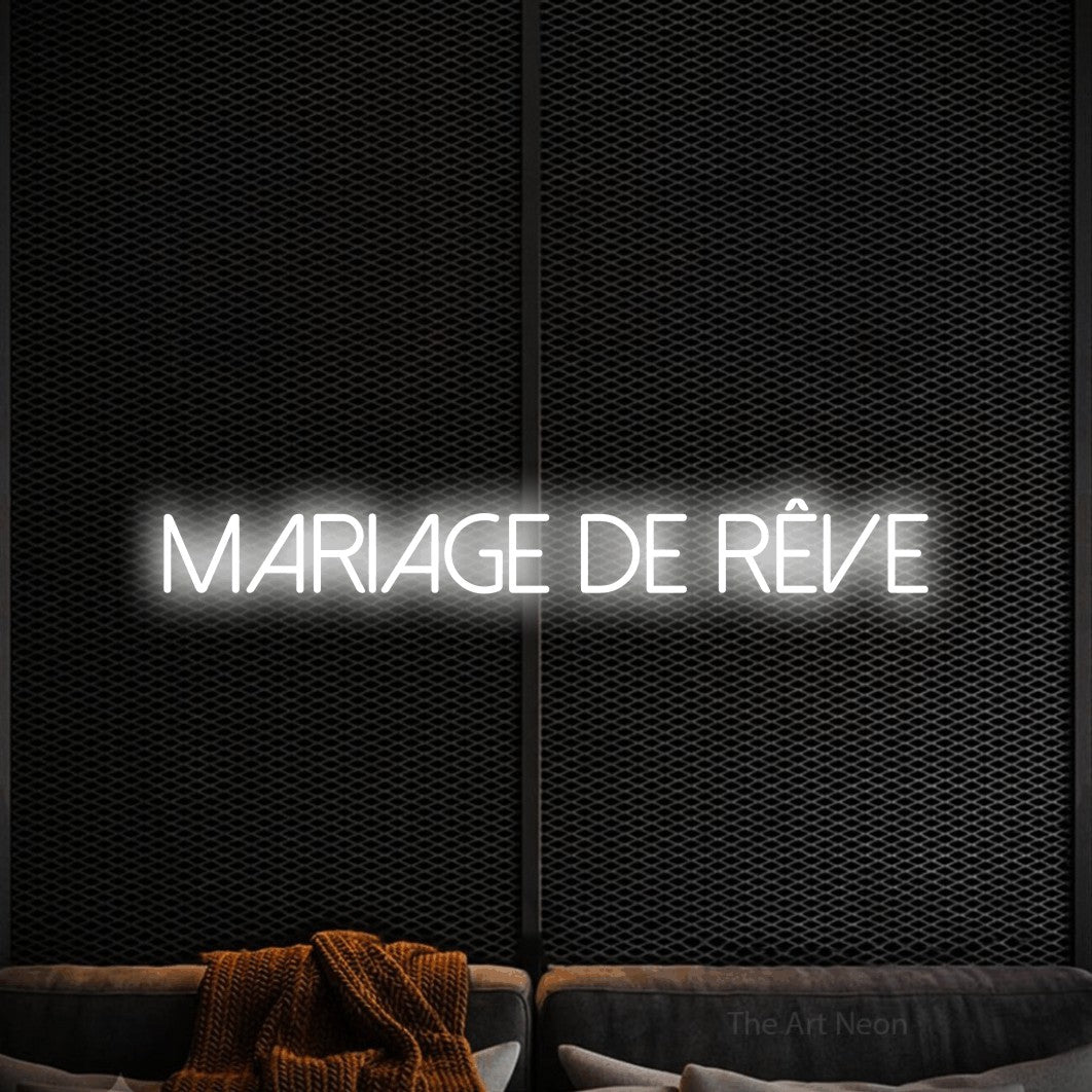 “Mariage de rêve” LED neon sign in cool white, with thin sans-serif lettering, shown against a modern dark-toned seating area.