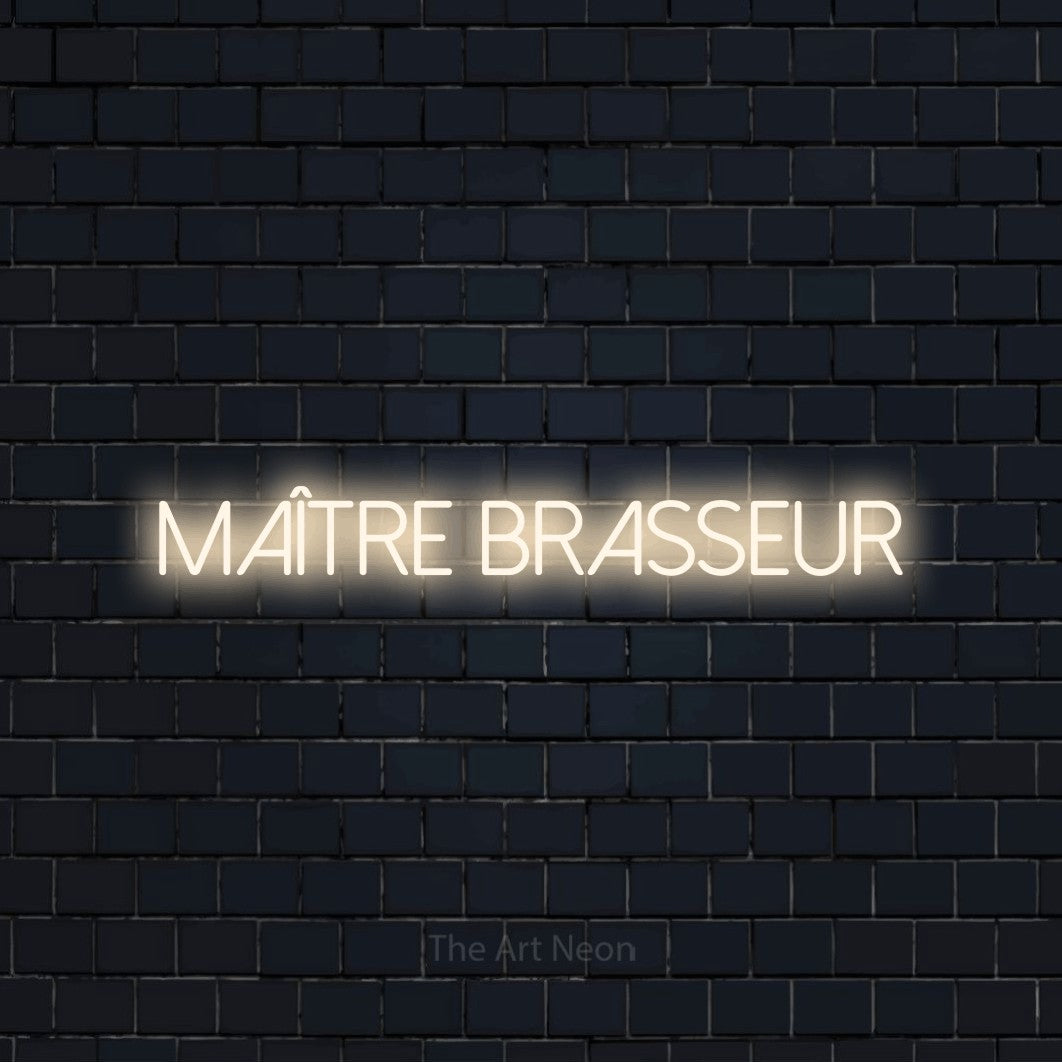 “Maître brasseur” LED neon sign in warm white, with thin sans-serif lettering, shown against a dark navy brick wall.