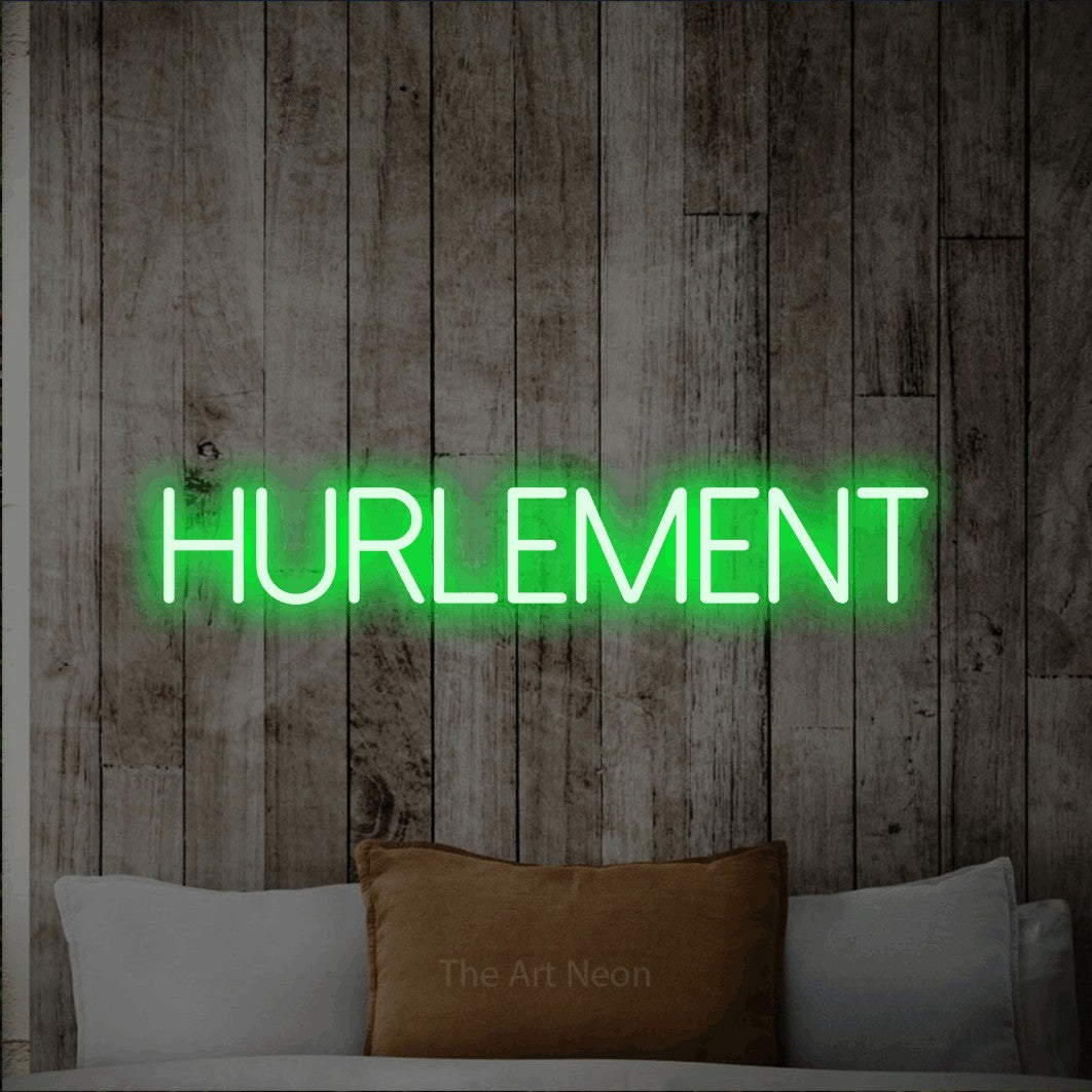 “Hurlement” LED neon sign in green, with thin sans-serif lettering, shown against a light rustic wood wall.