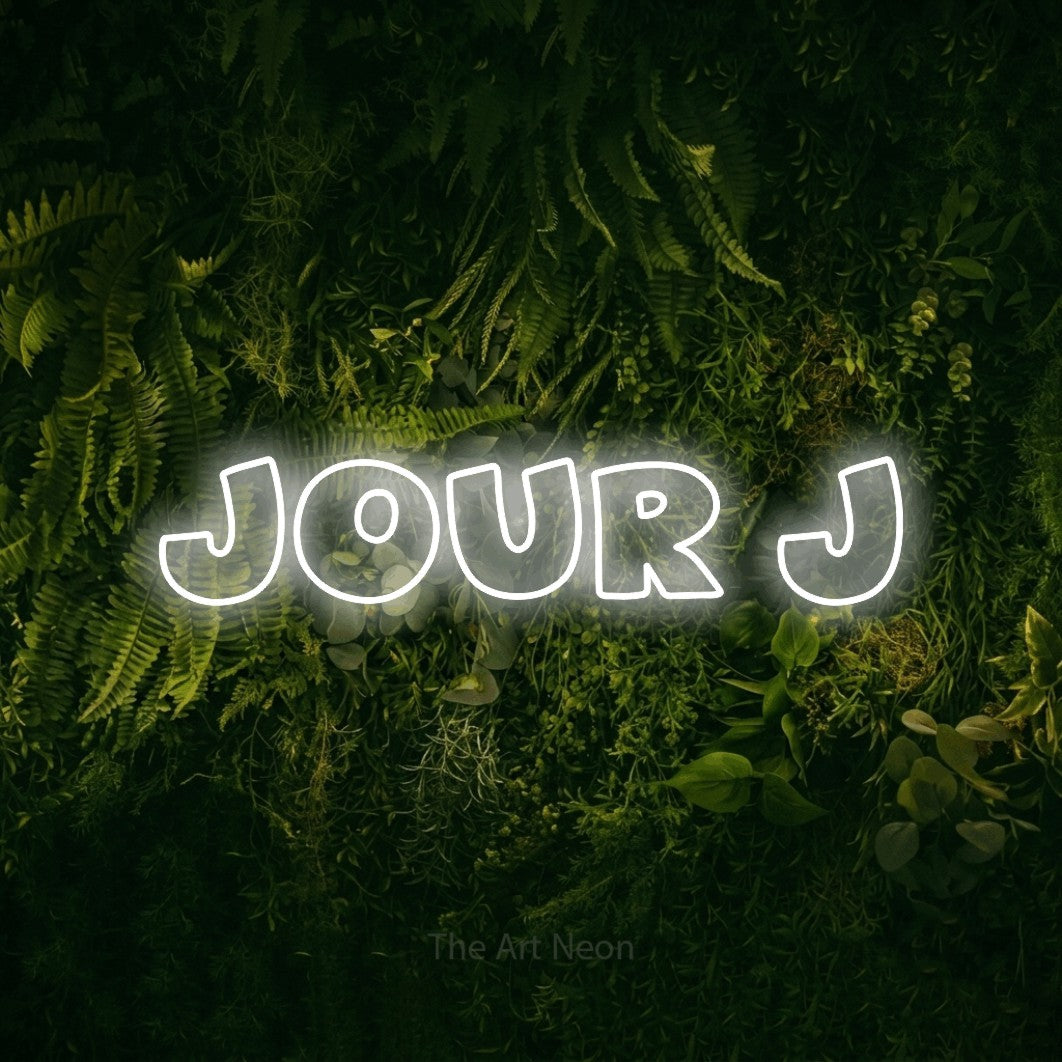 “Jour j” LED neon sign in cool white, with wide lettering with irregular outlines, shown against a dark moss and forest backdrop.