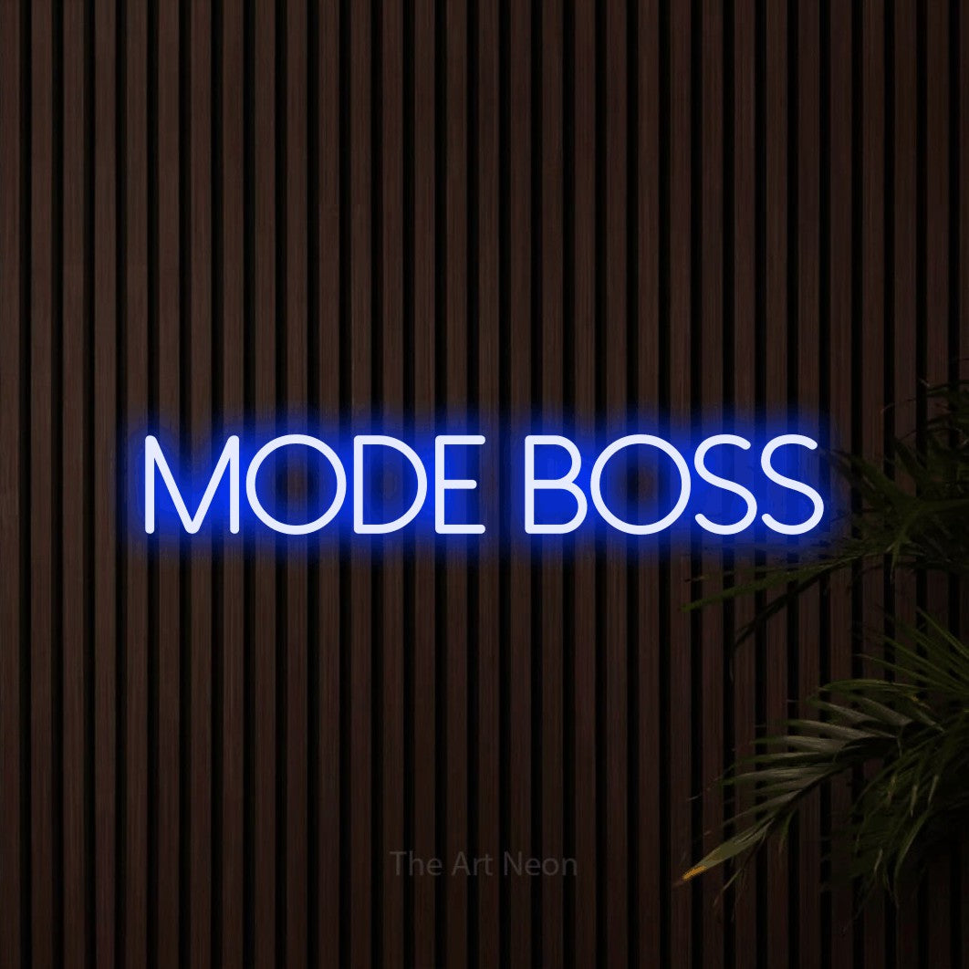 “Mode boss” LED neon sign in blue, with thin sans-serif lettering, shown against dark wooden wall slats.