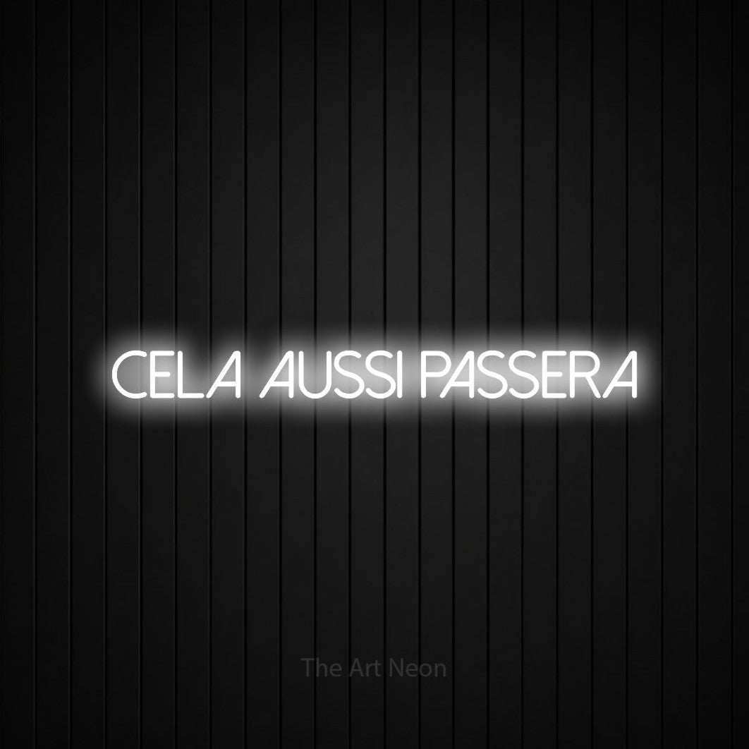 “Cela aussi passera” LED neon sign in cool white, with thin sans-serif lettering, shown against black vertical wall slats.