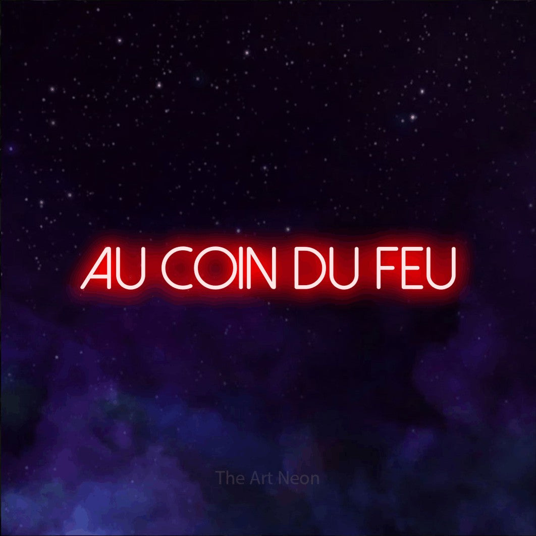 “Au coin du feu” LED neon sign in red, with thin sans-serif lettering, shown against a purple galaxy backdrop.