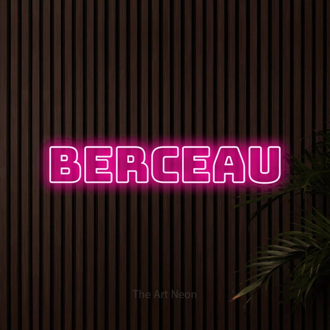 “Berceau” LED neon sign in hot pink, with bold outline lettering, shown against dark wooden wall slats.