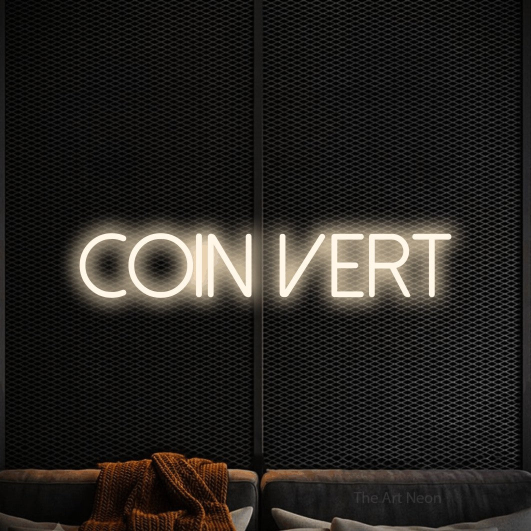 “Coin vert” LED neon sign in warm white, with thin sans-serif lettering, shown against a modern dark-toned seating area.