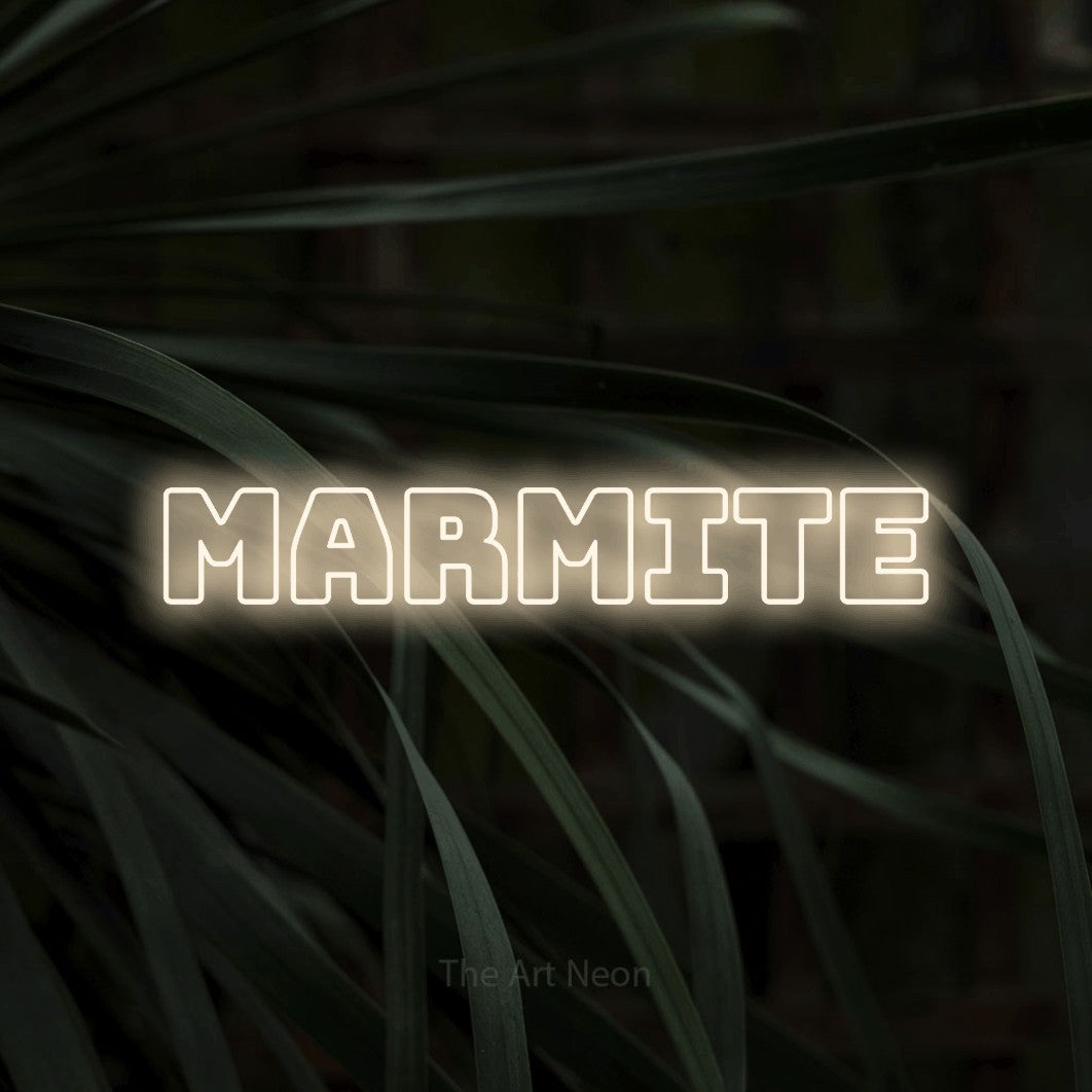 “Marmite” LED neon sign in warm white, with bold outline lettering, shown against a close-up of dark foliage.