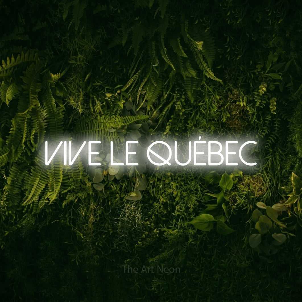 “Vive le Québec” LED neon sign in cool white, with thin sans-serif lettering, shown against a dark moss and forest backdrop.