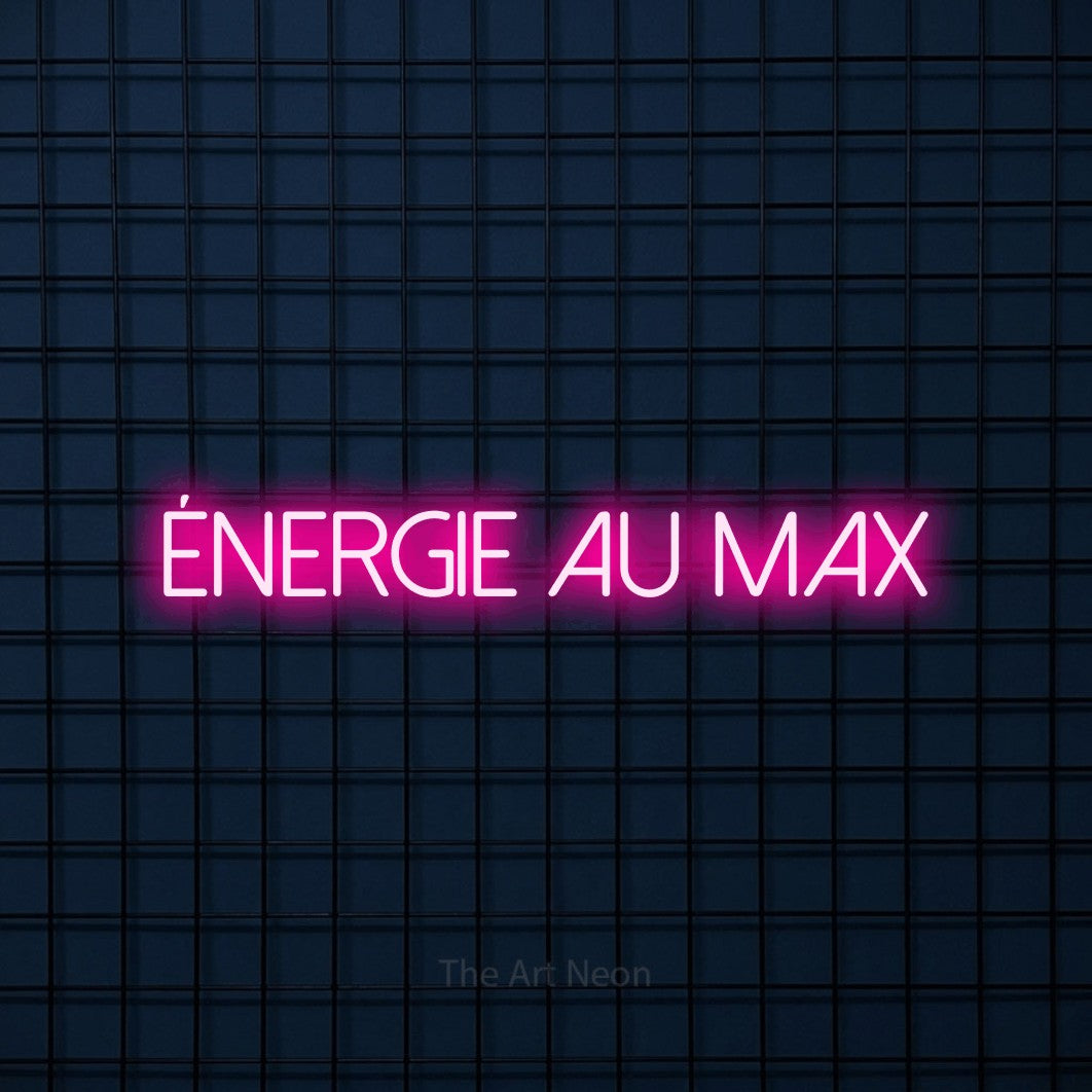 “Énergie au max” LED neon sign in hot pink, with thin sans-serif lettering, shown against a dark blue grid.