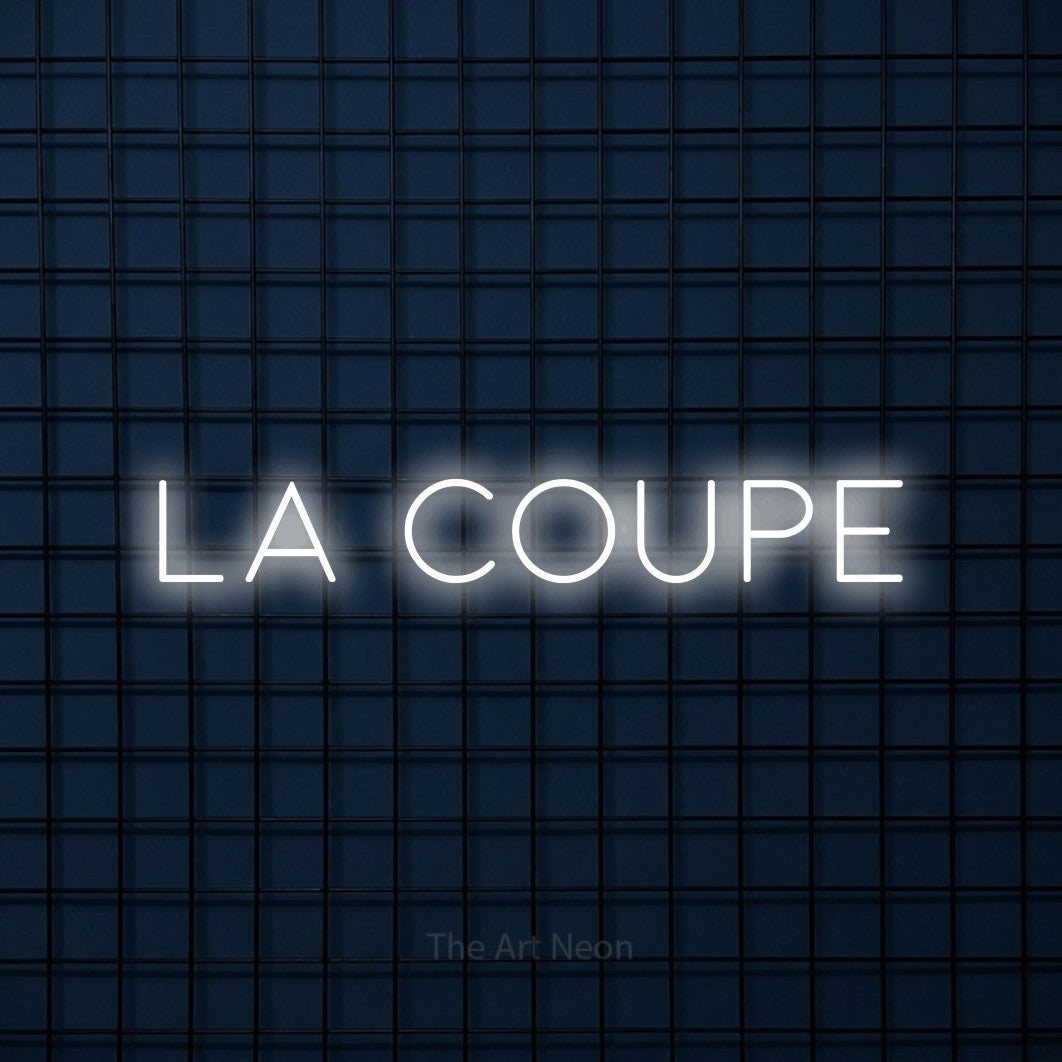 “La coupe” LED neon sign in cool white, with thin, widely spaced lettering, shown against a dark blue grid.