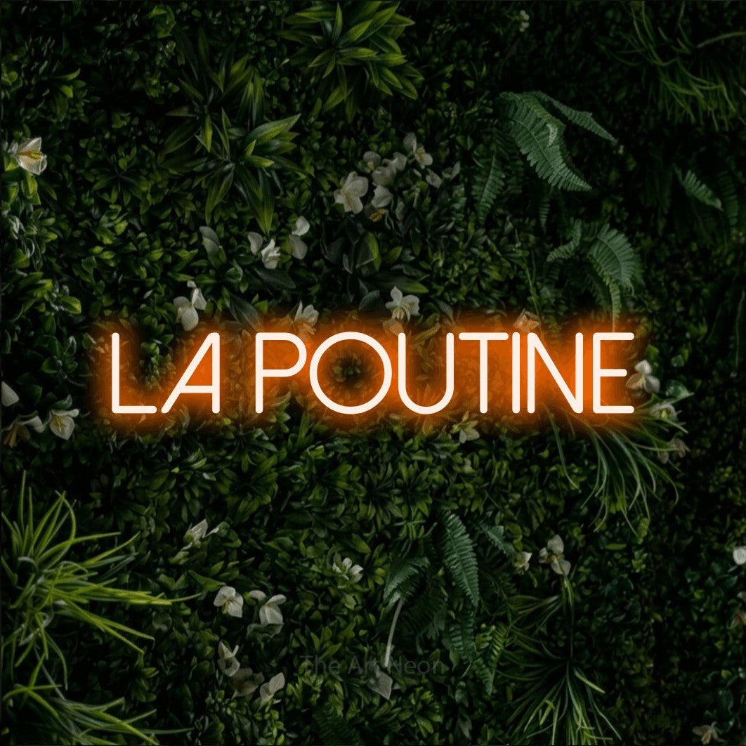 “La poutine” LED neon sign in orange, with thin sans-serif lettering, shown against a dense green plant wall.