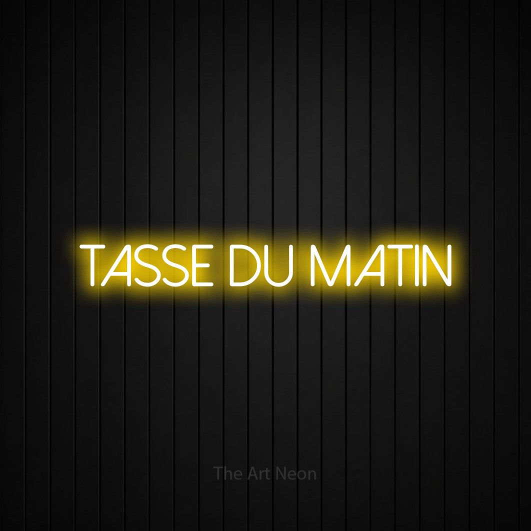 “Tasse du matin” LED neon sign in yellow, with thin sans-serif lettering, shown against black vertical wall slats.