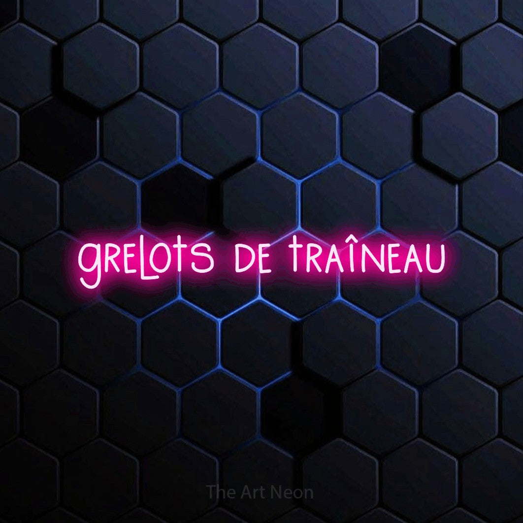 “Grelots de traîneau” LED neon sign in hot pink, with narrow hand-drawn lettering, shown against a dark blue honeycomb pattern.