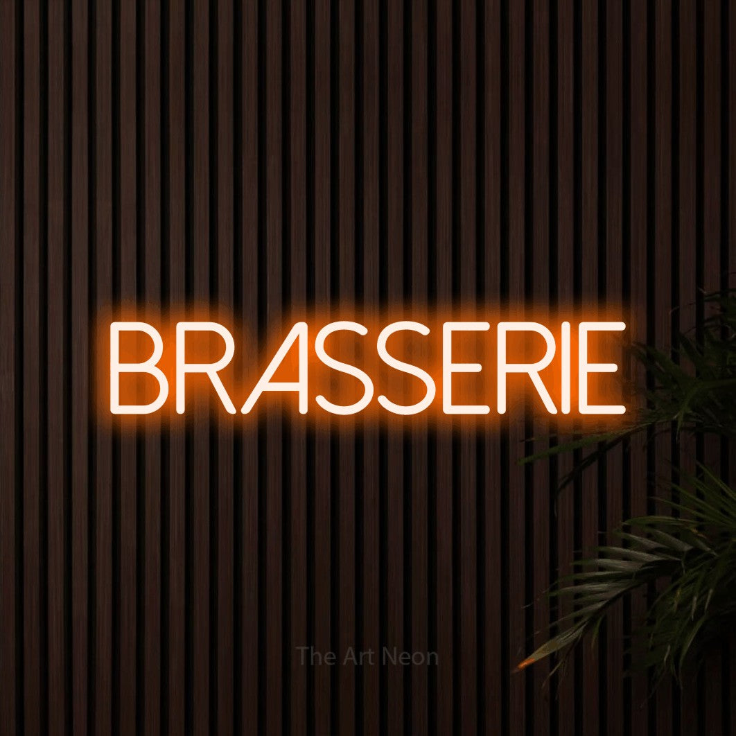 “Brasserie” LED neon sign in orange, with thin sans-serif lettering, shown against dark wooden wall slats.