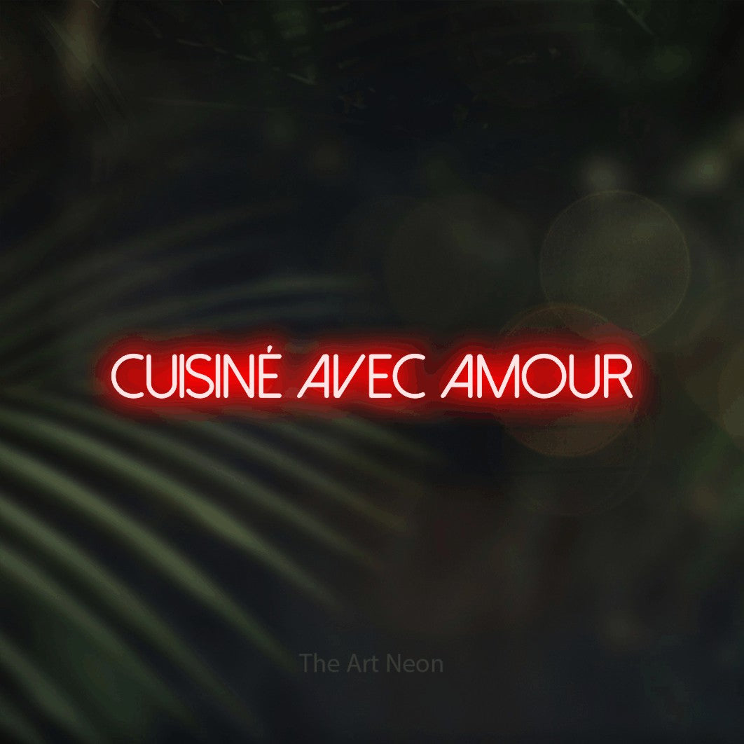 “Cuisiné avec amour” LED neon sign in red, with thin sans-serif lettering, shown against a blurred palm and bokeh-light backdrop.