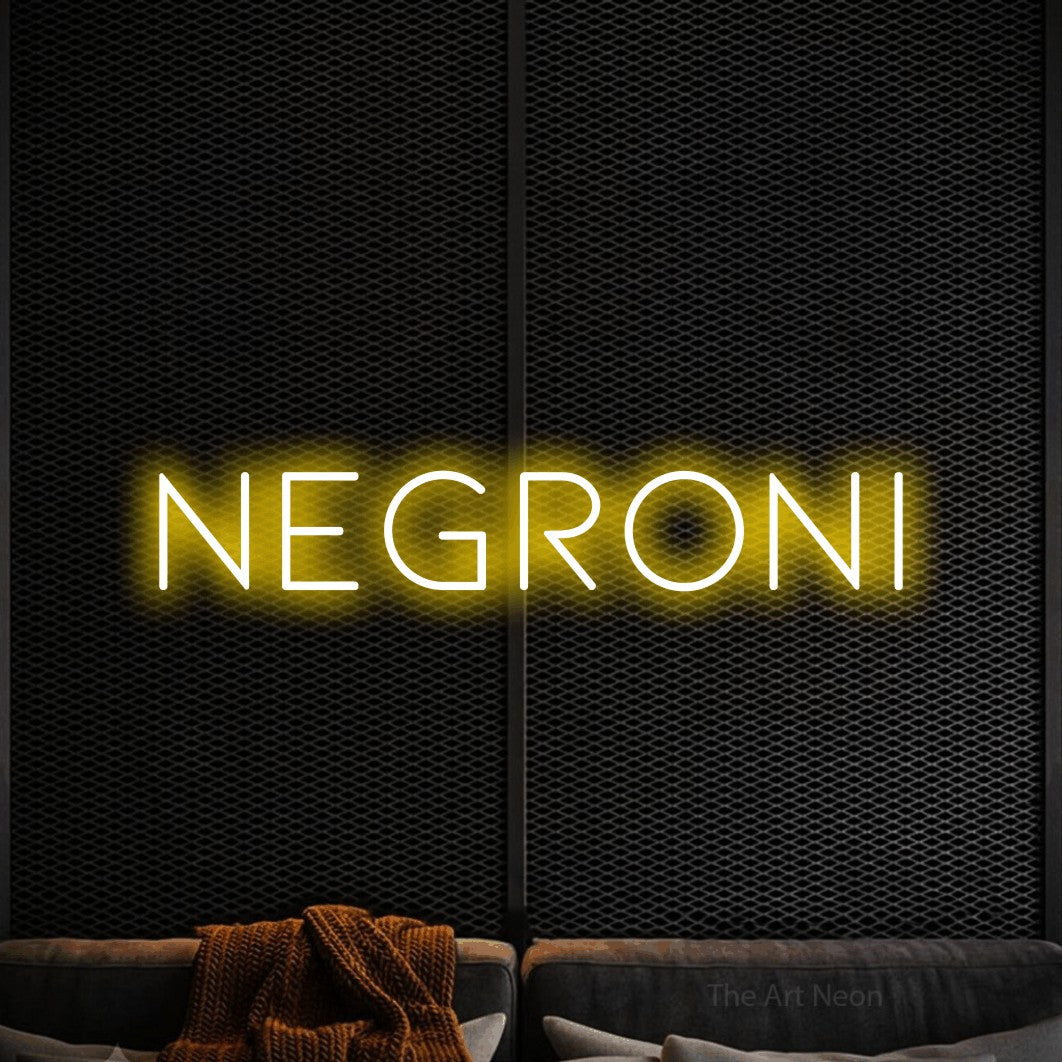 “Negroni” LED neon sign in yellow, with thin, widely spaced lettering, shown against a modern dark-toned seating area.